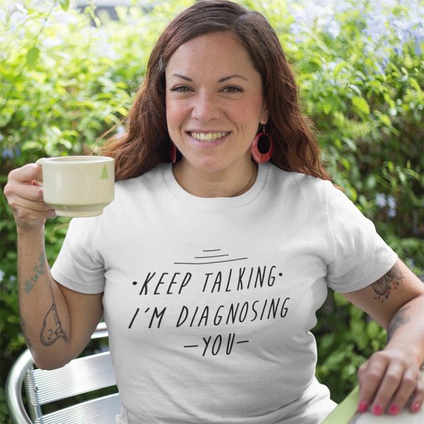 A Photo of a lady wearing a white t shirt with the words Keep Talking I'm Diagnosing You printed on the front