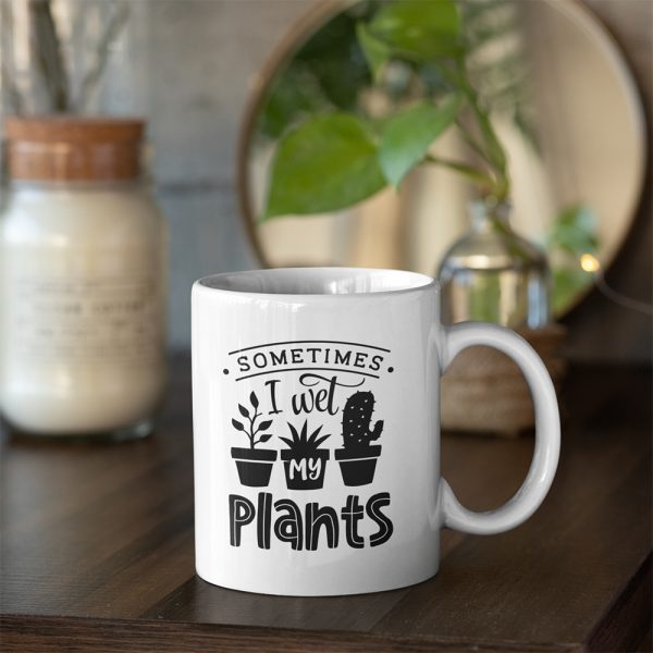 A photo of a mug with the words Sometimes I Wet My Plants printed on it along with images of potted plants