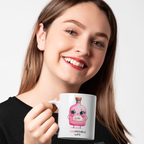 woman holding mug with gincredible wording and image of pink gin bottle